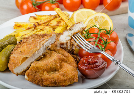 Big Chicken schnitzel with homemade chilli french fries Big Chicken schnitzel with homemade chilli french fries 39832732
