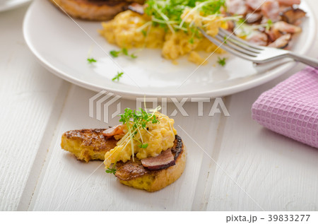 Scrambled eggs with French toast topped with watercress Scrambled eggs with watercress, french toast 39833277