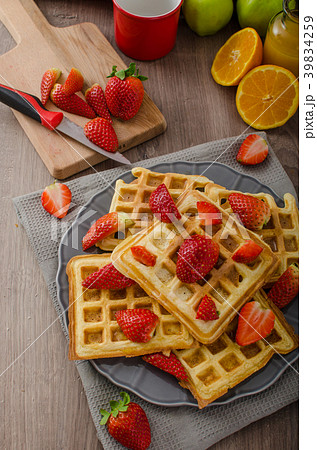 Homemade waffles with maple syrup and strawberries Homemade waffles with maple syrup and strawberries 39834259