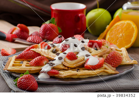 Homemade waffles with maple syrup and strawberries 39834352