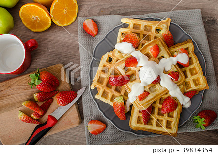 Homemade waffles with maple syrup and strawberries 39834354