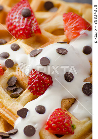 Homemade waffles with maple syrup and strawberries 39834358
