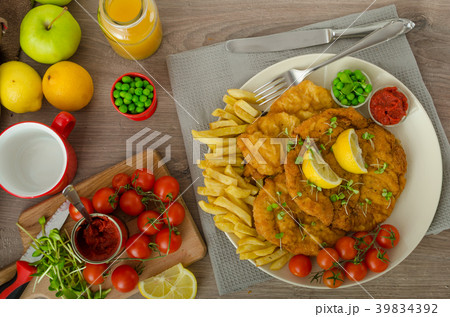 Schnitzel, french fries and microgreens salad 39834392