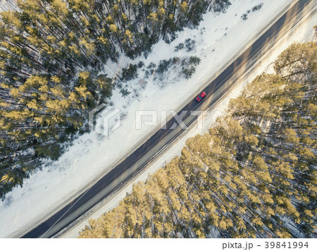 Snowy road with a moving car in winter Snowy road with a moving car in winter 39841994