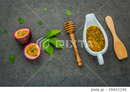 Fresh passion fruits set up on dark stone . 39842290