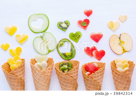 Various fruits in waffle cones  and heart shape. 39842314