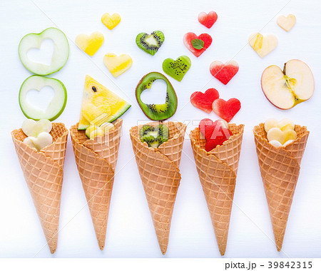 Various fruits in waffle cones  and heart shape . 39842315