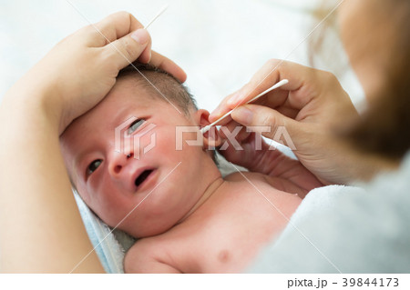 Asian newborn baby cleaning ear after bath Asian newborn baby cleaning ear after bath 39844173