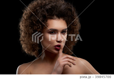 Charismatic curly model posing on black background 39845700