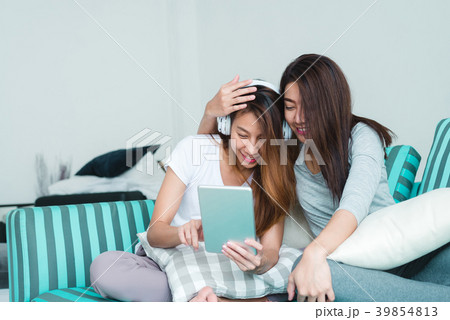 Asian women LGBT lesbian happy couple using tablet 39854813