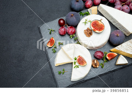 Camembert cheese and cut a slice on stone serving 39856851