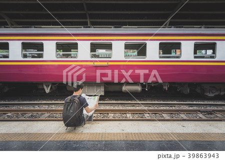 traveler with map at train station 39863943