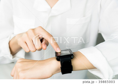 Woman touch screen digital clock in the display. 39865003