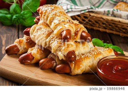 Rolled hot dog sausages baked in puff pastry 39866946