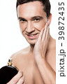 Handsome man using perfume isolated.  39872435