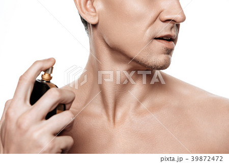 Handsome man using perfume isolated. Handsome man using perfume isolated. 39872472