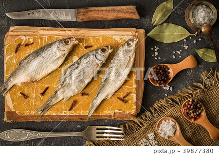 Dried fish on a dark concrete background Dried fish on a dark concrete background 39877380