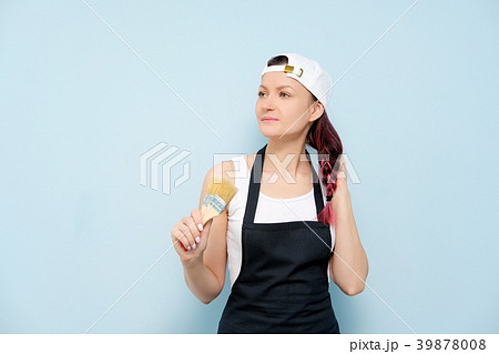 Girl painter, designer and worker paints a roller Girl painter, designer and worker paints a roller 39878008