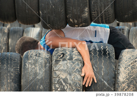 The racer overcomes the obstacle with the tire The racer overcomes the obstacle with the tire 39878208