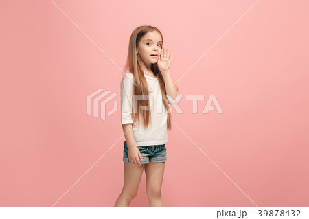 The young teen girl whispering a secret behind her 39878432
