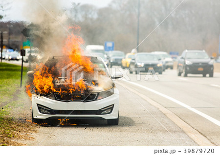 Burning car on fire on a highway road accident 39879720