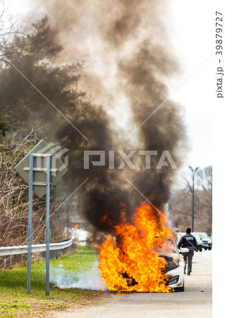 Burning car on fire on a highway road accident Burning car on fire on a highway road accident 39879727