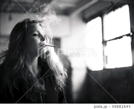 beautiful woman in ruined building smoking 39881645