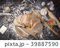 Male baker prepares bread. Male baker sprinkle the 39887590