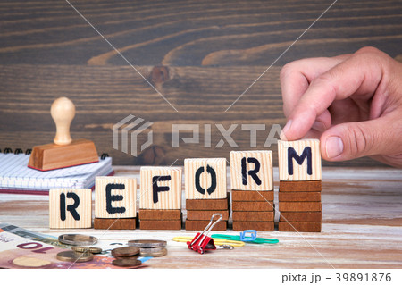 Reform concept. Wooden letters on the office desk, informative and communication background 39891876