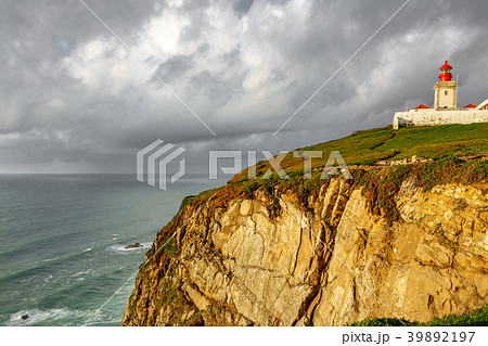 Lighthouse on top of cliff at dusk 39892197