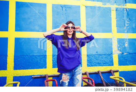 woman with long hair in jeans and sunglasses woman with long hair in jeans and sunglasses 39894182
