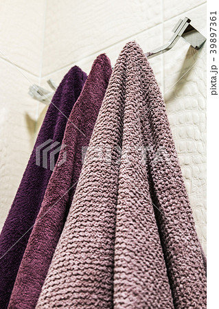towels of different colors hanging on a hanger  39897361