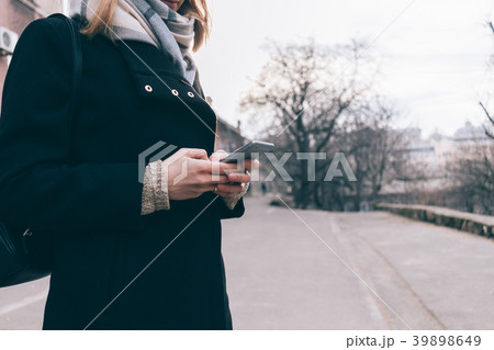 Smiling attractive young woman in coat Smiling attractive young woman in coat 39898649