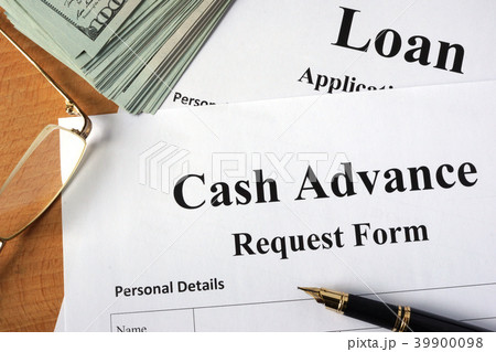 Cash advance form on a wooden table. Cash advance form on a wooden table. 39900098