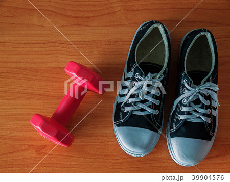 Sports shoe and dumbbell. 39904576
