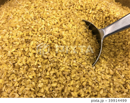 Raw burghul with metallic scoop close up shot. 39914499