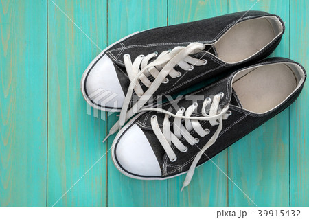 Sneakers on blue wooden background Sneakers on blue wooden background 39915432