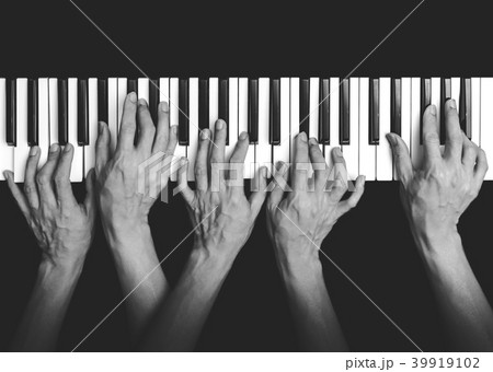 five hands playing on piano keys, black and white 39919102