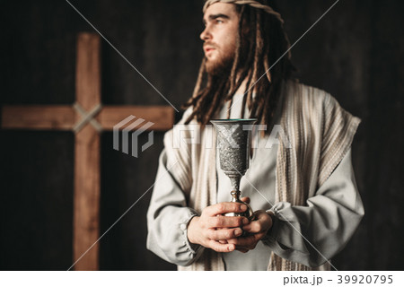 Jesus Christ holds a cup of wine Jesus Christ holds a cup of wine 39920795