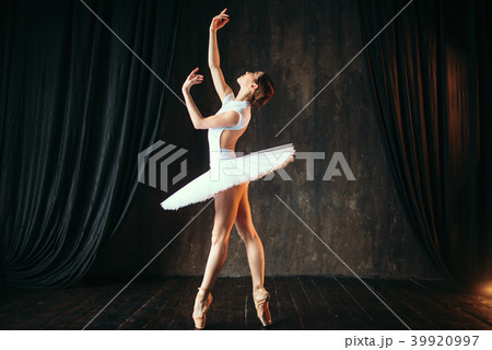 Graceful ballerina dancing in ballet class 39920997