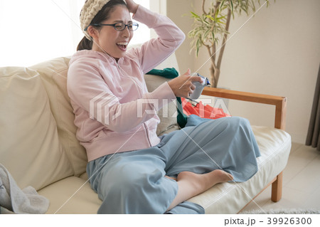 部屋でゲームに熱中する若い日本人女性 39926300