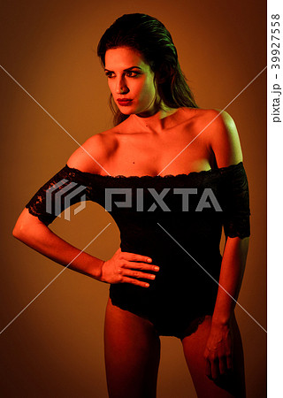 Young brunette woman in black lingerie with red and green lighti 39927558
