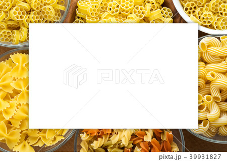 Macaroni ruote Different pasta in a glass and wooden bowl with pasta spirals on a brown rustic Macaroni ruote Different pasta in a glass and wooden bowl with pasta spirals on a brown rustic 39931827