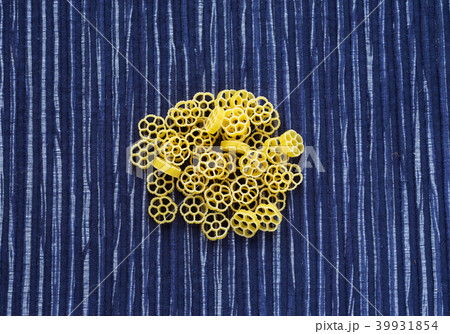 Macaroni ruote background with pasta on a striped blue white textured background. A view from the Macaroni ruote background with pasta on a striped blue white textured background. A view from the 39931854