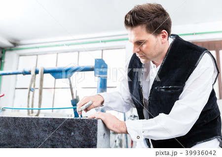 Stonemason working with compressed air at 39936042