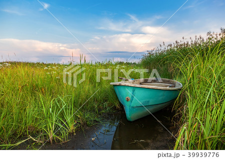 Old green plastic fishing boat at the lake Old green plastic fishing boat at the lake 39939776
