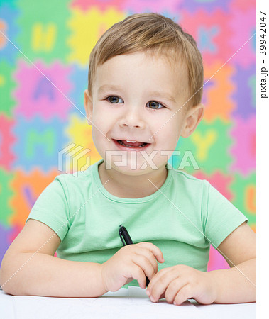 Little boy is writing on his copybook Little boy is writing on his copybook 39942047