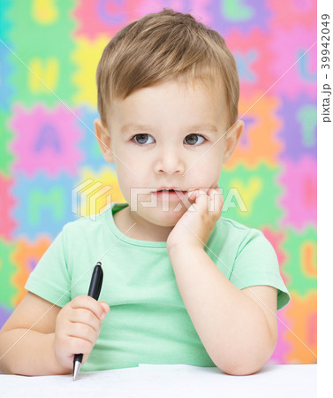 Little boy is writing on his copybook Little boy is writing on his copybook 39942049