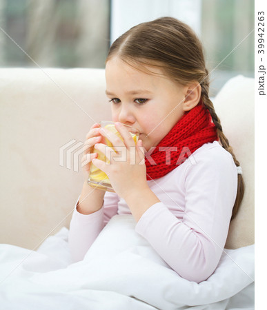 Ill little girl is drinking vitamin cocktail Ill little girl is drinking vitamin cocktail 39942263