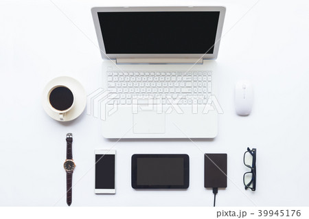 White desk office with laptop, smartphone and othe 39945176